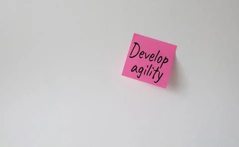 Develop agility symbol. Pink steaky note with concept words Develop Agility.. Stock Photos