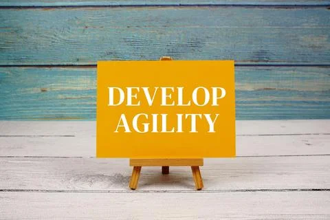 Develop Agility text written on paper card on wooden background 스톡 사진