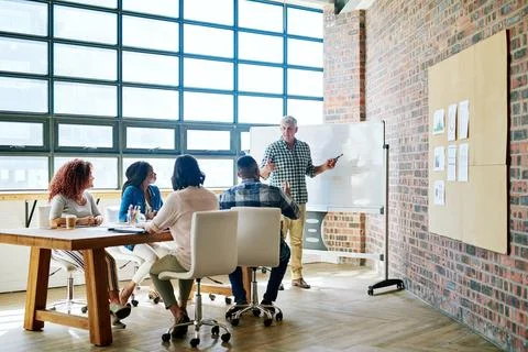 Develop a clear vision for your business. Shot of a businessman giving a pres Stock Photos