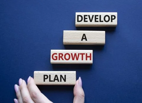 Develop a growth mindset symbol. Wooden blocks with words Develop a growth .. Stock Photos
