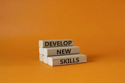 Develop New skills symbol. Concept word Develop New skills on wooden blocks.. Stock Photos