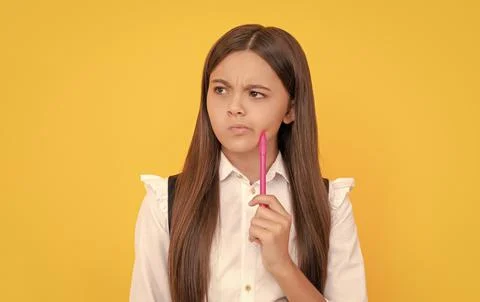 Develop new thinking. Thoughtful girl child yellow background. School education 스톡 사진