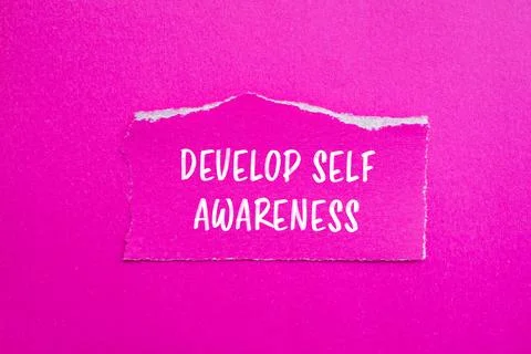 Develop self awareness words written on ripped paper with pink background Stock Photos