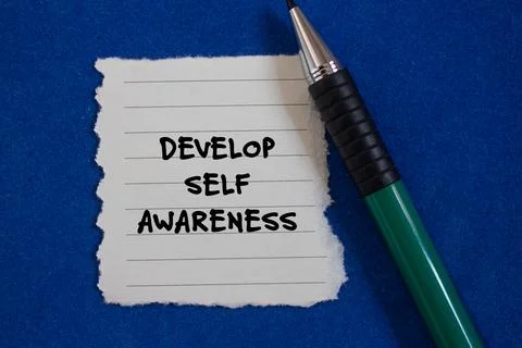 Develop self awareness words written on ripped with blue background Stock Photos