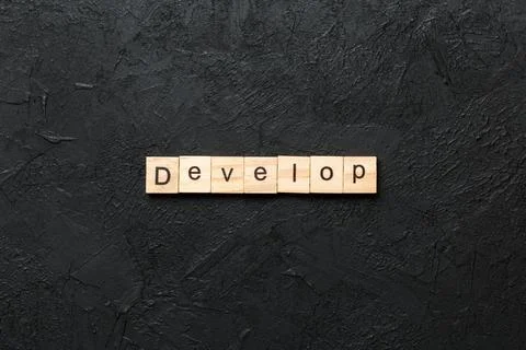 Develop word written on wood block. Develop text on cement table for your des Stockfoto's
