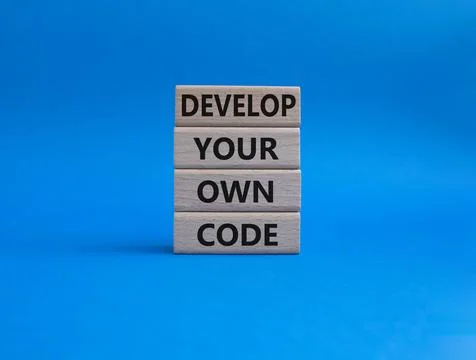 Develop your own code symbol. Concept words Develop your own code on wooden.. Stockfoto's