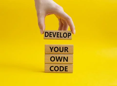 Develop your own code symbol. Concept words Develop your own code on wooden.. Stockfoto's