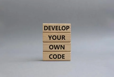 Develop your own code symbol. Concept words Develop your own code on wooden.. Foto stock