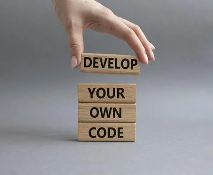 Develop your own code symbol. Concept words Develop your own code on wooden.. 스톡 사진