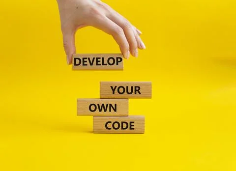 Develop your own code symbol. Concept words Develop your own code on wooden.. Stockfoto's