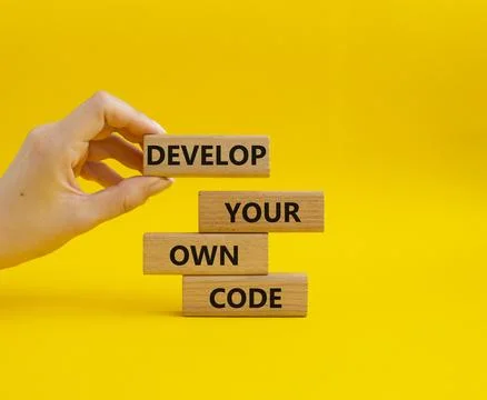 Develop your own code symbol. Concept words Develop your own code on wooden.. 스톡 사진