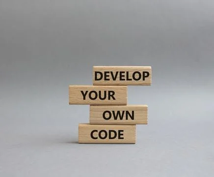 Develop your own code symbol. Concept words Develop your own code on wooden.. 스톡 사진