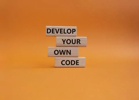 Develop your own code symbol. Concept words Develop your own code on wooden.. Stock-Fotos