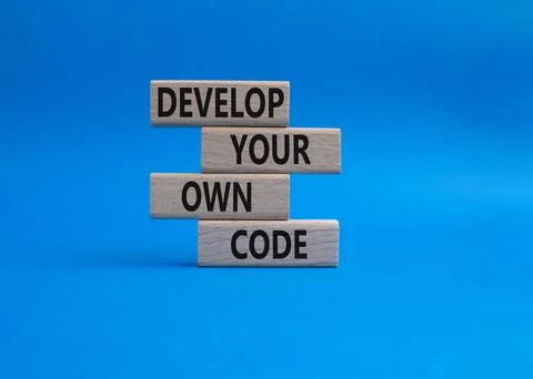 Develop your own code symbol. Concept words Develop your own code on wooden.. Stock-Fotos