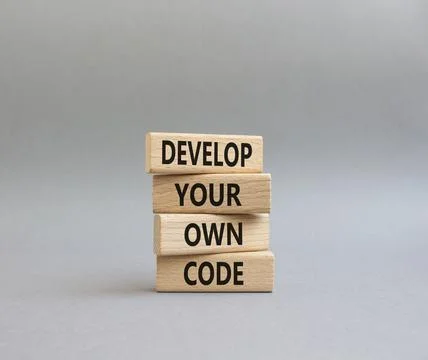 Develop your own code symbol. Concept words Develop your own code on wooden.. Stockfoto's