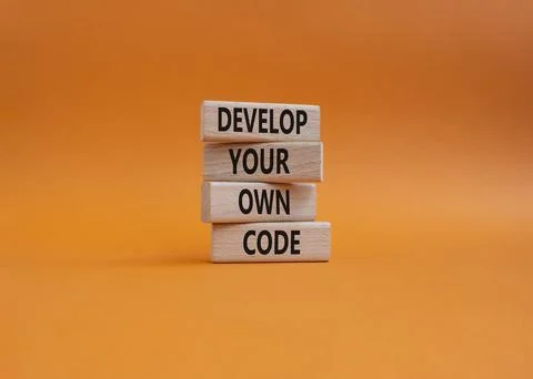 Develop your own code symbol. Concept words Develop your own code on wooden.. 库存照片
