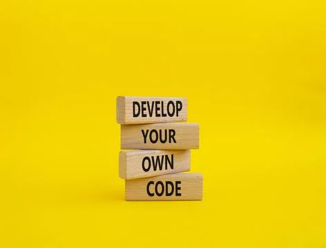 Develop your own code symbol. Concept words Develop your own code on wooden.. 스톡 사진
