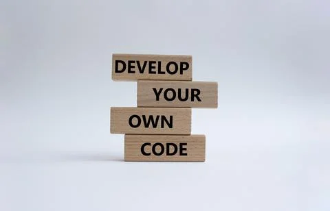 Develop your own code symbol. Concept words Develop your own code on wooden.. Stockfoto's