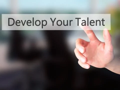 Develop Your Talent - Hand pressing a button on blurred background concept .  Stock Photos