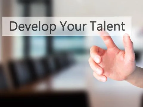 Develop Your Talent - Hand pressing a button on blurred background concept .  Stock Photos