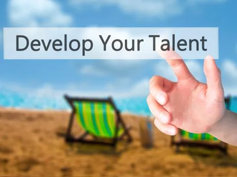 Develop Your Talent - Hand pressing a button on blurred background concept .  Stock Photos