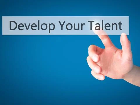 Develop Your Talent - Hand pressing a button on blurred background concept .  Stock Photos