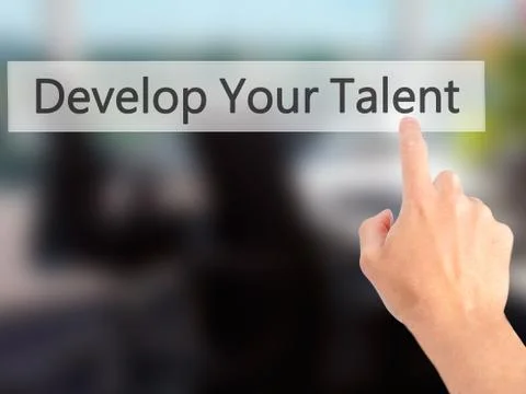 Develop Your Talent - Hand pressing a button on blurred background concept .  Stock Photos