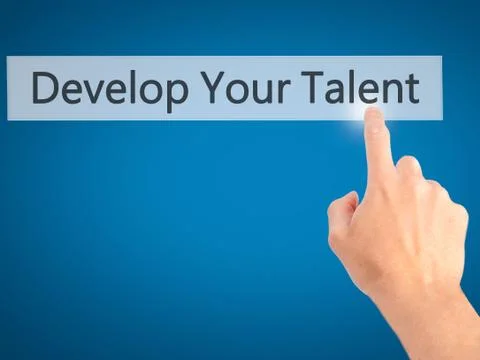 Develop Your Talent - Hand pressing a button on blurred background concept .  Stock Photos