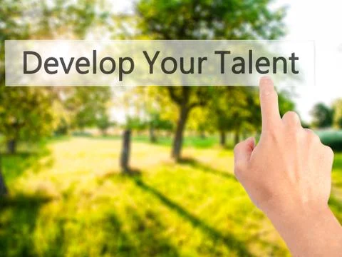 Develop Your Talent - Hand pressing a button on blurred background concept .  스톡 사진