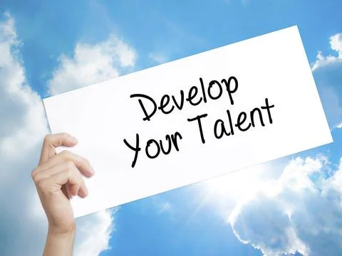 Develop Your Talent Sign on white paper. Man Hand Holding Paper with text.... Stock Photos
