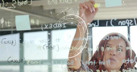 Developer adjusting sticky note on glass board with code in office workspace, Stock Photos
