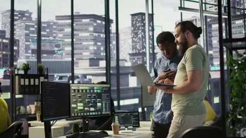 Developer and colleague checking code on notebook, doing brainstorming Stock Footage 318162540