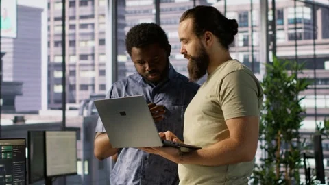 Developer and colleague checking code on notebook, doing brainstorming Stock Footage 318232306