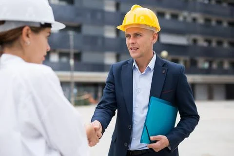 Developer and master builder shaking hands 写真素材