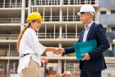 Developer and master builder shaking hands 写真素材