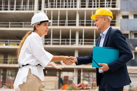 Developer and master builder shaking hands 写真素材