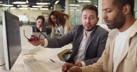 Developer and mentor guiding programmer at office computer during coding Stock Footage 341884891