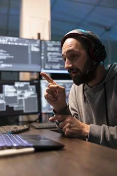 Developer Attending Virtual Meeting During Coding Session Foto stock