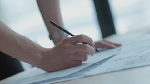 Developer in bright office stands in front of desk and draws. Close-up Video stock 125011314