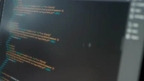 Developer is browsing html code on the computer screen. HTML Web Page Code Stock Footage 141018384