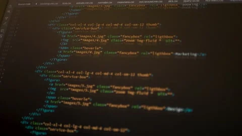 Developer is browsing html code on the computer screen. HTML Web Page Code Stock Footage 143385602