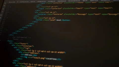 Developer is browsing html code on the computer screen. HTML Web Page Code Stock Footage 143385616