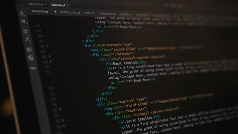 Developer is browsing html code on the computer screen. HTML Web Page Code Stock Footage 143385645