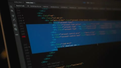 Developer is browsing html code on the computer screen. HTML Web Page Code Stock Footage 143385650