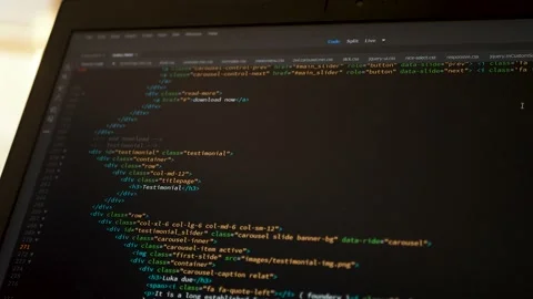 Developer is browsing html code on the computer screen. HTML Web Page Code Stock Footage 143386103