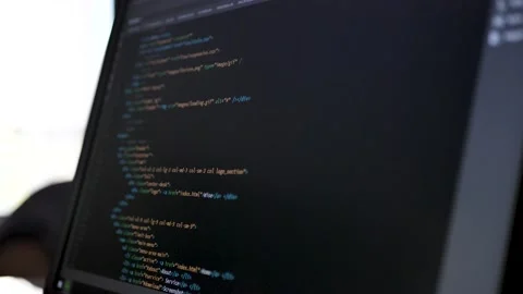 Developer is browsing html code on the computer screen. Side view. HTML Stock Footage 209551726
