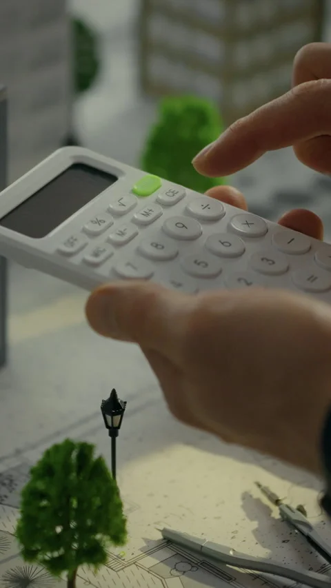 Developer calculating residential area metrics using a calculator in an urba Stock Footage 331570104
