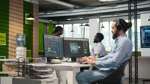 Developer coding with AI language model assistance in office, listening music Stock Footage 313168102