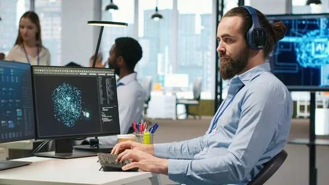 Developer coding with AI language model assistance in office, listening music Stock Photos