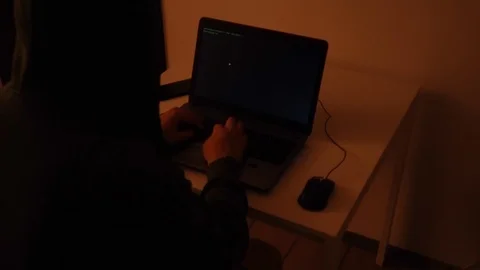Developer coding in a dark room on a laptop when a glitch turns into code rai Stock Footage 120616485